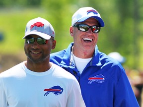 Buffalo Bills general manager Doug Whaley, left, and head coach Rex Ryan share a laugh during their team's NFL football training camp in Pittsford, N.Y., Friday, July 31, 2015. (AP Photo/Bill Wippert)