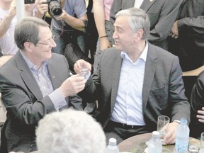 Turkish Cypriot Leader Mustafa Akinci, left, and Greek Cypriot President Nicos Anastasiades clink glasses in old Nicosia earlier this year. The encounter was a symbolic gesture underscoring a recent thaw in relations between the two Cypriot sides, estranged since a Turkish invasion in 1974 triggered by a brief Greek-inspired coup. The leaders are proposing a federal republic with two states to help free Turkish-Cypriots from their isolation and expand economic opportunities on both sides. (Yiannis Kourtoglou, Reuters file photo)