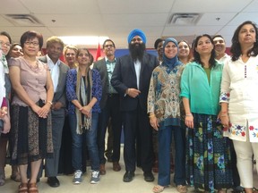 Conservative Minister of State for Multiculturalism Tim Uppal poses for a photo with staff at the Edmonton Mennonite Centre for Newcomers on Friday. MATT DYKSTRA/EDMONTON SUN