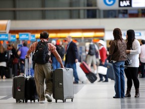 Passengers with their baggage move through the Tom Bradley International Terminal at Los Angeles International Airport (LAX), California in this April 24, 2013 file photo. (REUTERS/Patrick T. Fallon/Files)