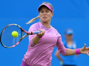 Eugenie Bouchard returns the ball to Alison Riske during their second-round match at the WTA Eastbourne International tournament in Eastbourne, England on June 23, 2015. (AFP PHOTO/GLYN KIRK)