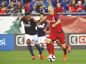 Toronto FC’s Michael Bradley controls the ball against New England Revolution forward Juan Agudelo when the two teams met earlier this season. That game ended in a 1-1 draw. (USA TODAY SPORTS)