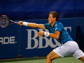 Vasek Pospisil of Canada returns a forehand to Marcos Baghdatis of Cyprus during the BB&T Atlanta Open at Atlantic Station on July 31, 2015 in Atlanta, Georgia. Baghdatis would go on to eliminate Pospisil. (Kevin C. Cox/Getty Images/AFP)