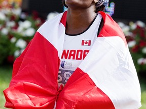 Canada’s Kendra Clarke wraps herself into the Canadian flag after winning the women’s 400 metre final during the 2015 Panamerican Junior Athletics Championships at Foote Field on July 31, 2015. Photo by David Bloom/Edmonton Sun