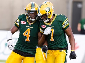 The Edmonton Eskimos' Adarius Bowman (4) and Kenny Stafford (7) celebrate Stafford's touchdown against the Saskatchewan Roughriders during first quarter CFL action at Commonwealth Stadium, in Edmonton Alta. on Friday July 31, 2015. David Bloom/Edmonton Sun/Postmedia Network