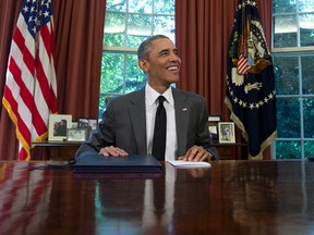President Barack Obama smiles after signing the three-month highway funding bill in the Oval Office of the White House in Washington on July 31, 2015. (AP Photo/Carolyn Kaster)