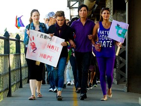 Chevi Rabbit, second from right, leads a march across the High Level Bridge during the NOH8 rally in Edmonton on Thursday, August 2, 2012. The march and rally was in response to an alleged hate crime attack on Chevi Rabbit, a local university student. CODIE MCLACHLAN/EDMONTON SUN