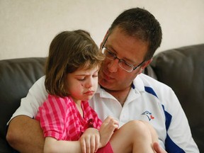 Nelina MacPherson and dad Darryl are seen at their Mississauga home July 28, 2015. Nelina, who had a rare type of brain tumour, died Jan. 19, 2016. (Stan Behal/Toronto Sun)