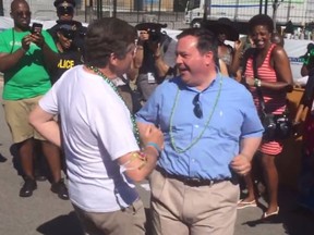 Mayor John Tory and Minister of Defence Jason Kenney dance during the Caribbean Carnival parade Saturday, Aug. 1, 2015. (framegrab)