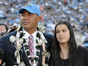 In this Nov. 27, 2011, file photo, former San Diego Charger Junior Seau stands with his daughter, Sydney, at his induction into the San Diego Chargers Hall of Fame. Sydney Seau will now get to speak on video at the ceremony for her father entering the Pro Football Hall of Fame on Aug. 8. Citing previous policies on posthumous inductions, the Hall originally barred Sydney Seau from making a speech. Seau, who committed suicide in 2012, is one of seven men being inducted this year. (AP Photo/Denis Poroy/File)