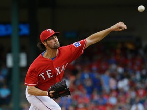 Rangers starting pitcher Cole Hamels throws during the first inning of his debut with Texas against the San Francisco Giants in Arlington, Texas, Saturday, Aug. 1, 2015. (AP Photo/LM Otero)