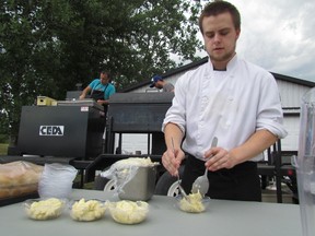 Erik Fawdry, of the Grind Cafe and Catoring Co., dishes up compound butter at the Canada Food Day Dinner on Saturday August 1, 2015 at the Oil Museum of Canada in Oil Spring, Ont. Paul Morden/Sarnia Observer/Postmedia Network