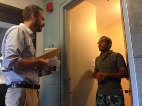 Winnipeg South Centre NDP candidate Matt Henderson speaks to a constituent while door-knocking Sunday, Aug, 2, 2015 near Osborne Village. (David Larkins/Winnipeg Sun/Postmedia Network)