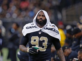 In this Nov. 24, 2014, file photo, New Orleans Saints outside linebacker Junior Galette walks along the bench during an NFL football game against the Baltimore Ravens in New Orleans. (AP Photo/Jonathan Bachman, File)