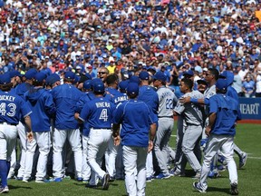 Alex Rios #36 of the Kansas City Royals yells as both dugouts empty onto the field after a hit by pitch in the eighth inning during MLB game action against the Toronto Blue Jays on August 2, 2015 at Rogers Centre in Toronto, Ontario, Canada.   Tom Szczerbowski/Getty Images/AFP