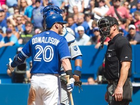 Toronto Blue Jays Josh Donaldson complains to home plate umpire Jim Wolf after he was brushed back by a pitch for the third time in the game during eighth inning AL baseball action between the Blue jays and Kansas City Royals in Toronto on Sunday August 2, 2015. THE CANADIAN PRESS/Fred Thornhill