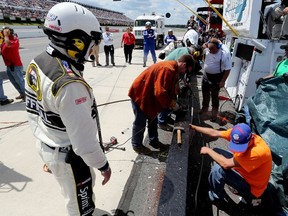 Track officials work to repair a section of the pit wall damaged in an on-track incident involving Kasey Kahne, driver of the #5 Aquafina Chevrolet, during the NASCAR Sprint Cup Series Windows 10 400 at Pocono Raceway on August 2, 2015 in Long Pond, Pennsylvania.   Jerry Markland/Getty Images/AFP