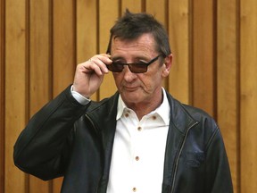 AC/DC drummer Phil Rudd appears in the Tauranga District Court in Tauranga, New Zealand Monday, Aug. 3, 2015. Rudd pleaded not guilty on Monday to breaching the rules of his home detention sentence by drinking alcohol. (Alan Gibson/New Zealand Herald via AP)