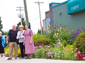 Gerry Teahen and Lorraine Hunter, Communities in Bloom judges, met with and complimented Judy Unruh of Builders World Carpet One, the winner of the Businesses in Bloom commercial category in 2015.