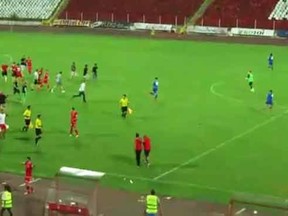 Players for Israeli side Ashdod flee CSKA Sofia supporters.