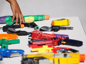 A girl leaves a toy gun on a table during the "Culture of lawfulness" campaign at a school in Ciudad Juarez October 24, 2012. (REUTERS/Joe Luis Gonzalez)