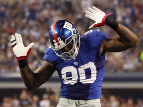 New York Giants defensive end Jason Pierre-Paul celebrates after sacking Dallas Cowboys quarterback Tony Romo in the second half of their NFL football game in Arlington, Texas, in this file photo taken September 8, 2013. REUTERS/Mike Stone/Files