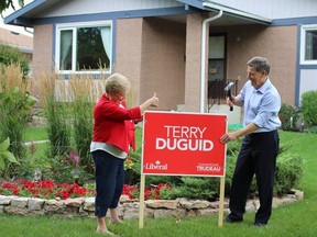 United Fire Fighters of Winnipeg president Alex Forrest shared a photo of Liberal Winnipeg South candidate Terry Duguid placing a lawn sign in his yard. Forrest said he's publicly supporting Duguid as “a great supporter of public safety for over 2 decades.” (Facebook.com)