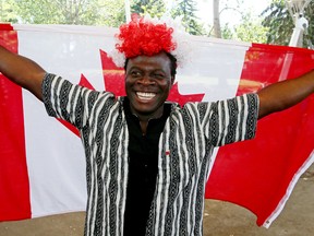 Bokolo Chea smiles with joy after the swearing in of new Canadians citizenship ceremony on the ground of Hawerlak Park in Edmonton on Sunday Aug. 3, 2015. Chea fled Liberia with his parents and brother when he was sixteen years old. He ended up along in a refugee camp for two years after getting separated with the rest of his family. Chea met his future wife in the refugee camp, immigrated to Canada where he is now a crane operator and a welding apprentice. It took Chea 17 years to find his parents and brother, he is a very grateful to Canada for everything it has offered him. Tom Braid/Edmonton Sun/Postmedia Network.