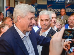 Prime Minister Stephen Harper shakes a few hands after speaking before a full room of supporters during a campaign stop in Kingston on Monday. (Julia McKay/The Whig-Standard)