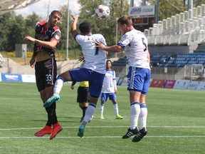 Ottawa Fury FC defender Rafael Alves and FC Edmonton players Christian Raudales and Albert Watson attempt to get their head on a ball during NASL action in Fort McMurray Alta. on Sunday, Aug. 2, 2015. (Robert Murray/Postmedia Network)