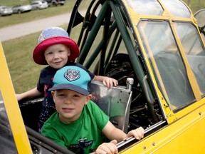 Wyatt, in front, and Cole sit in one of the Harvard aircraft out the Tillsonburg Regional Airport on Saturday, August 1 when the Canadian Harvard Aircraft Association hosted a public open house. The boys were visiting the planes with their grandparents Peter and Lynda Curtis. (BRUCE CHESSELL/Sentinel-Review)