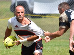 Brian Meindl of the Belleville Bulldogs Old Boys gets tied up while looking for options during Over-45's rugby action at the annual Can Am Rugby tournament last weekend at Saranac Lake, NY. (Submitted photo)
