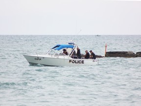The OPP Marine Unit is seen searching Lake Huron along the Kincardine breakwall, a few hundred metres where 16-year-old Lucas Johnson of Goderich went missing while swimming there Sunday afternoon and is presumed drowned. (TROY PATTERSON/KINCARDINE NEWS)