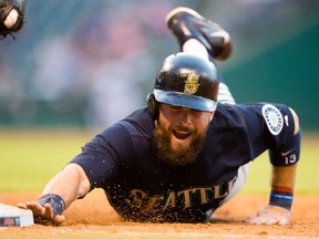 Dustin Ackley of the Seattle Mariners dives back to first base on a pick-off attempt against the Cleveland Indians at Progressive Field on June 10, 2015 in Cleveland. (Jason Miller/Getty Images/AFP)