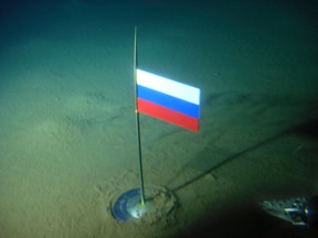 In this Thursday, Aug. 2, 2007 file made available by the Association of Russian Polar Explorers on Wednesday, Aug. 8, 2007, photo a titanium capsule with the Russian flag is seen seconds after it was planted by the Mir-1 mini submarine on the Arctic Ocean seabed under the North Pole during a record dive. (AP Photo/Association of Russian Polar Explorers, file)