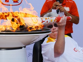Parapan Am Games torch bearer Karen Kitchen, of Belleville, lights the community cauldron after the relay in Belleville Tuesday, August 4, 2015. She called the experience "awesome." 

Luke Hendry/The Intelligencer