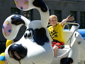 Liam Vince, 5, of London enjoys a ride on the midway at the London Ribfest in Victoria Park on Friday. (MORRIS LAMONT, The London Free Press)