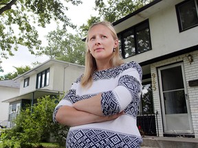 Chancellor Drive resident Jennifer Bottema stands outside her home in Winnipeg, Man. Tuesday Aug. 4, 2015. Bottema and her family have been expropriated to make way for phase two of rapid transit.