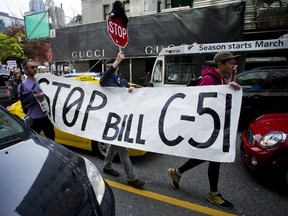 Protesters walk through traffic while demonstrating against Bill C-51, the Canadian federal government's proposed anti-terrorism legislation during a rally in Vancouver, British Columbia April 18, 2015.  REUTERS/Ben Nelms