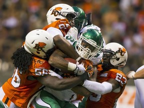 Saskatchewan Roughriders RB Anthony Allen is tackled by numerous BC Lions during the second half of their CFL football game in Vancouver on July 10, 2015. (REUTERS/Ben Nelms)