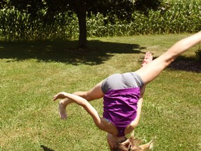 Rachel Gras performs an aerial somersault in her front yard.(Shaun Gregory/Huron Expositor)