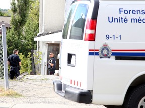 Greater Sudbury Police Services officers investigate at a home near the scene of an assault on Mountain Street in Sudbury on Tuesday August 4, 2015. Gino Donato/Sudbury Star