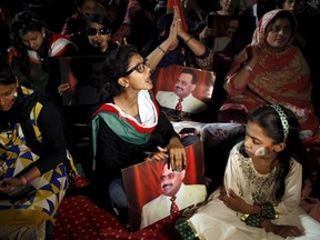 A supporter of Pakistan's Muttahida Qaumi Movement (MQM) political party holds a poster of MQM chief Altaf Hussain while chanting slogans during a by-election campaign rally in Karachi April 18, 2015. (REUTERS/Akhtar Soomro)