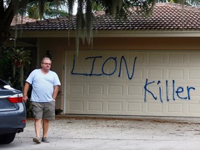 Private Investigator for the Palmer family, Walter Zalisko, of Global Investigative group in Fort Myers walks out of the Marco Island home of dentist Walter J. Palmer on Aug. 4, 2015. Zalisko said no vandalism was found inside. (Corey Perrine/Naples Daily News via AP)