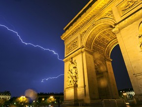 The dramatic Arc de Triomphe, built to honor Napoleon's victories, dominates Paris' skyline day and night. (photo: Dominic Arizona Bonuccelli)