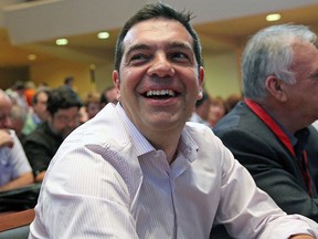 Greek Prime Minister Alexis Tsipras laughs during a central committee of leftist Syriza party in Athens, July 30, 2015. REUTERS/Yiannis Kourtoglou