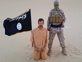 This image made from a militant video posted on a social media website on Wednesday, Aug. 5, 2015, which has been verified and is consistent with other AP reporting, purports to show a militant standing next to another man who identifies himself as 30-year-old Tomislav Salopek, kneeling down as he reads a message at an unknown location. The video purportedly released by the Islamic State group threatens to kill the Croatian hostage if Egyptian authorities do not release "Muslim women" held in prison within 48 hours. (Militant website via AP)