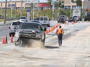 Crews clean up Falconbridge road where an early morning accident involving a garbage truck and another large vehicle result in a large amount of  diesel fuel spilling on the roadway in Sudbury, Ont. on Wednesday August 5, 2015. Gino Donato/Sudbury Star/Postmedia Network