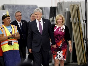 Prime Minister Stephen Harper and his wife Laureen, right, and Finance Minister Joe Oliver, second from left, visit a tile and stone manufacturing company in Toronto August 4, 2015. (REUTERS/Chris Helgren)