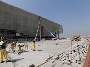 Workers are pictured at the construction site of the handball venue at the Rio 2016 Olympic Park in Rio de Janeiro August 5, 2015. (REUTERS/Sergio Moraes)